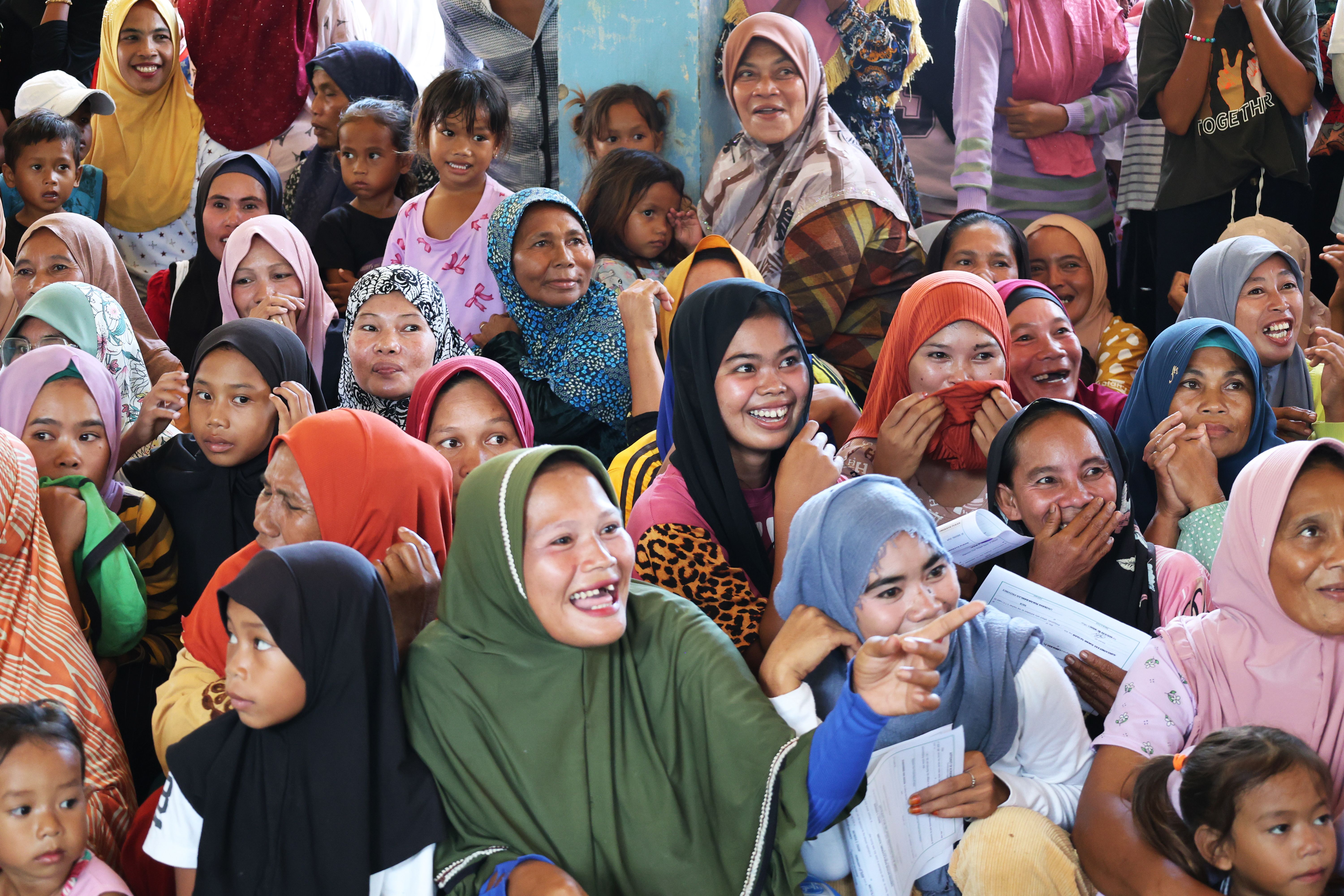 In Brgy. Amaloy, Ungkaya Pukan, Sama Bajau mothers and children waited eagerly for their newly issued birth certificates. Their joyful smiles and anticipation reflected their hopes for recognition, opportunity, and a brighter future.